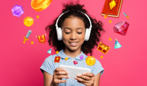 Young girl playing mobile video game in headphones
