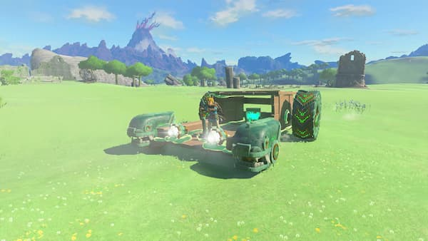 Link stands on a wide tractor-like contraption in the middle of a large field.