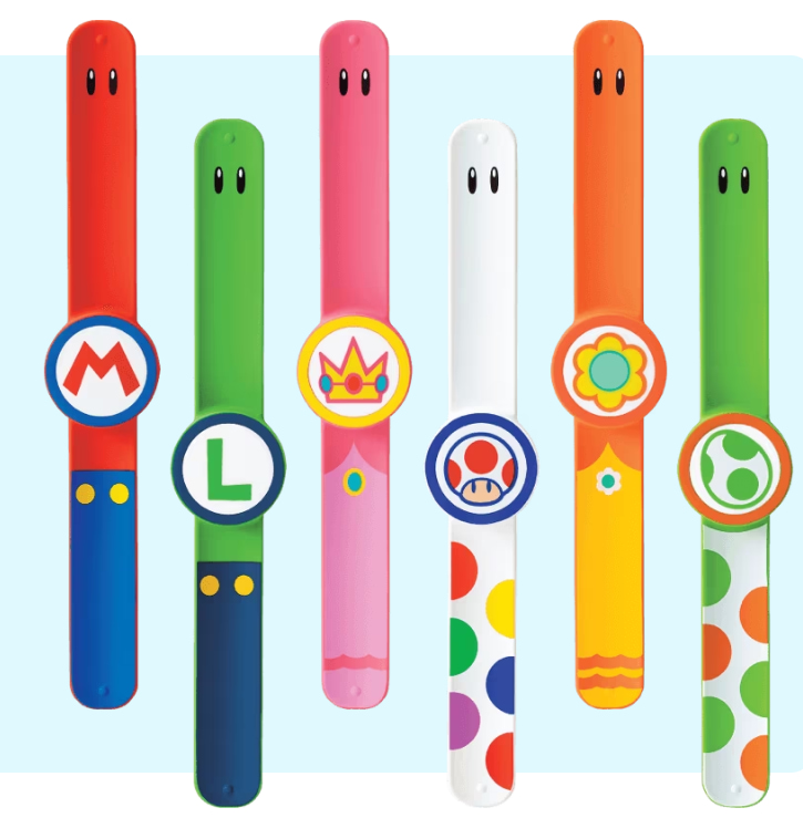 Six bracelet-like Power-Up Bands from super Nintendo World. Each of the bands evoke imagery from a specific character. From left to right: Mario, Luigi, Princess Peach, Toad, Daisy, Yoshi. 
