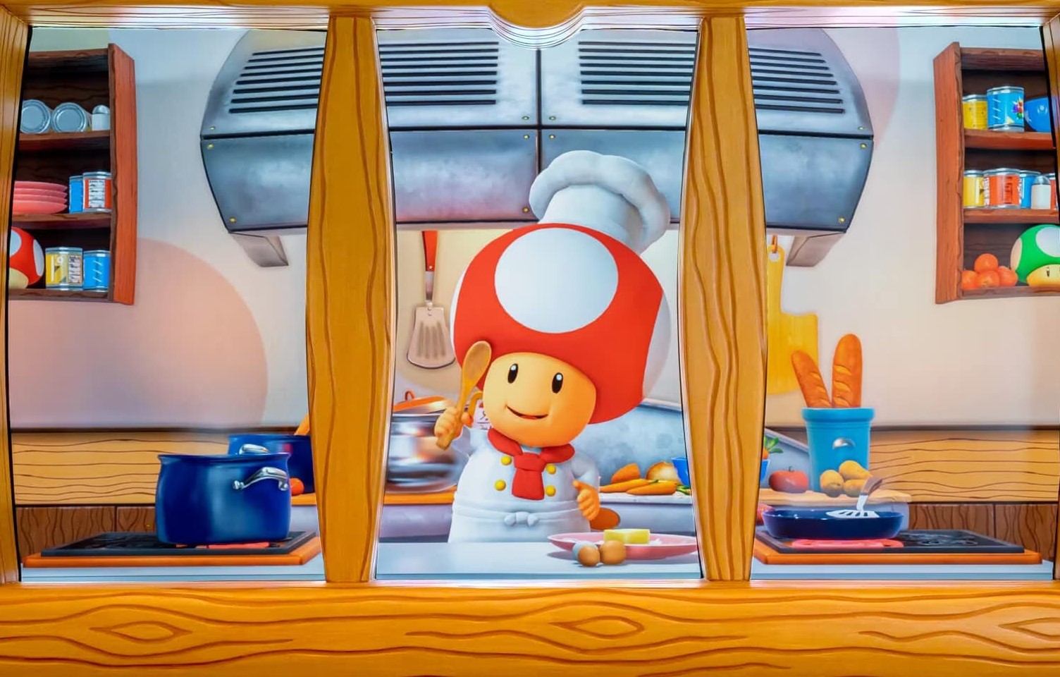 Toad from Super Mario stands in a kitchen wearing a chef outfit. He is holding a little wooden spoon with ingredients evocative of various Super Mario items and Power Ups around him.