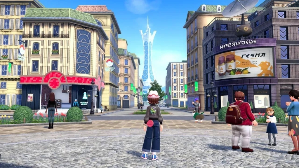 A trainer stands in the middle of a bustling street in Lumiose City. The Paris-inspired cobblestone Streets contain buildings and cafes. Pokémon and citizens dot the surrounding area.